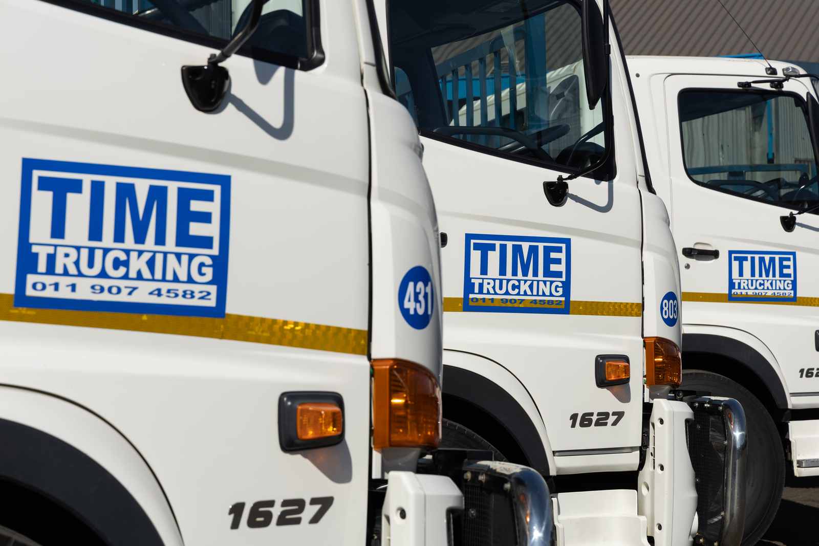 TIME Trucking branding on the fleet's truck cabs