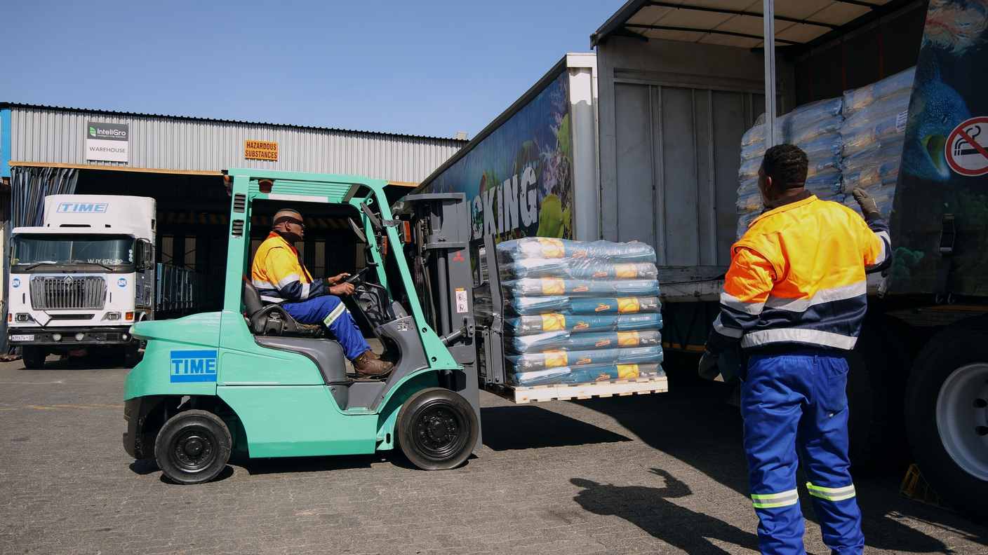 TIME Trucking team carefully handling cargo during loading