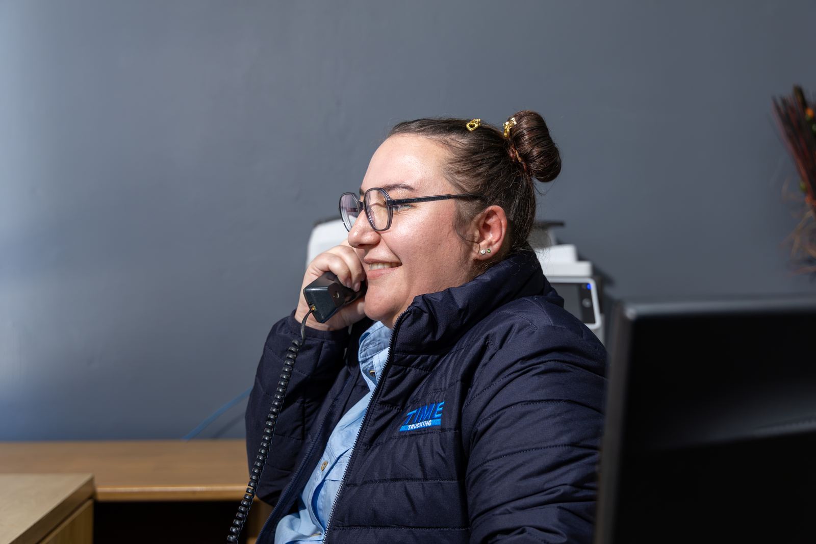 TIME Trucking team member speaking with a customer by phone